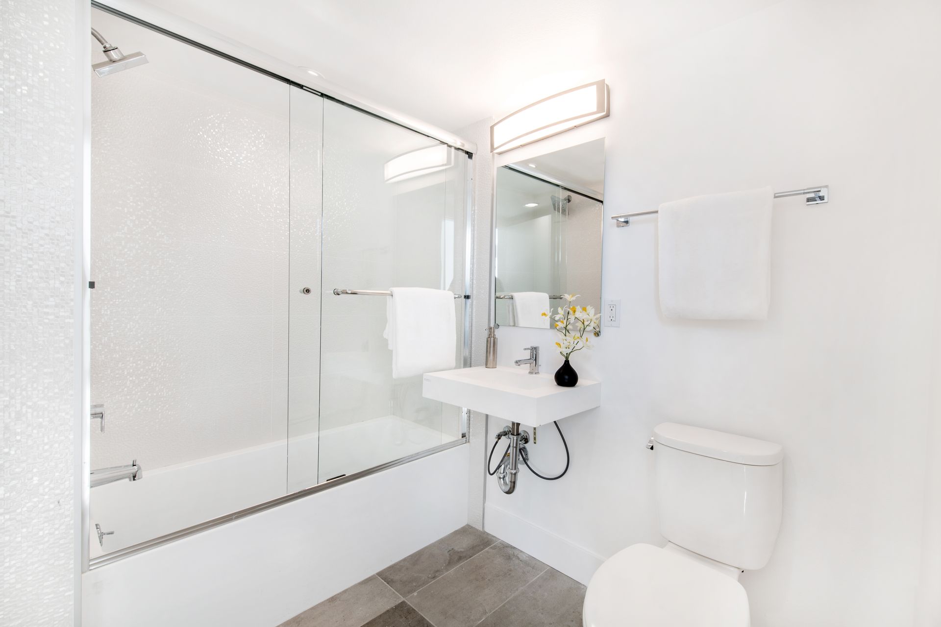 A bathroom with a sink , toilet , and bathtub.