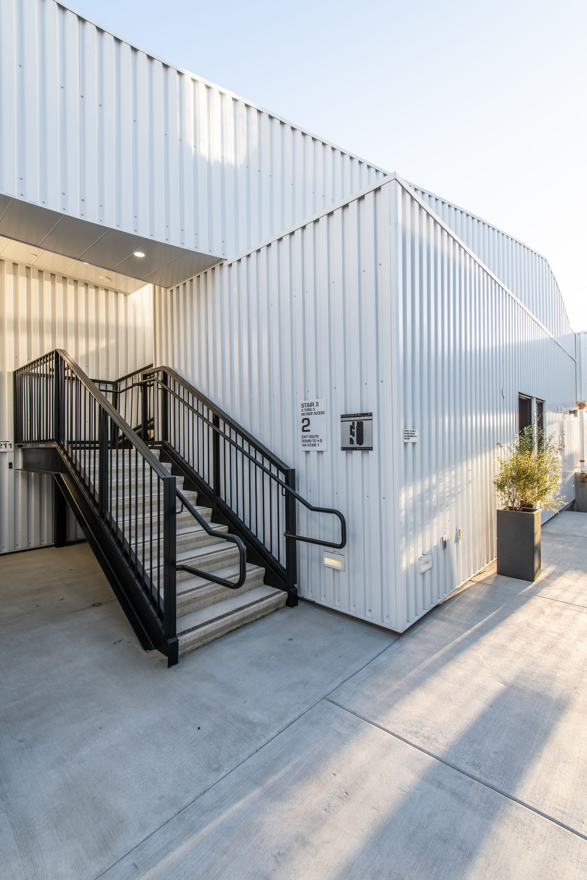A white building with stairs leading up to it.