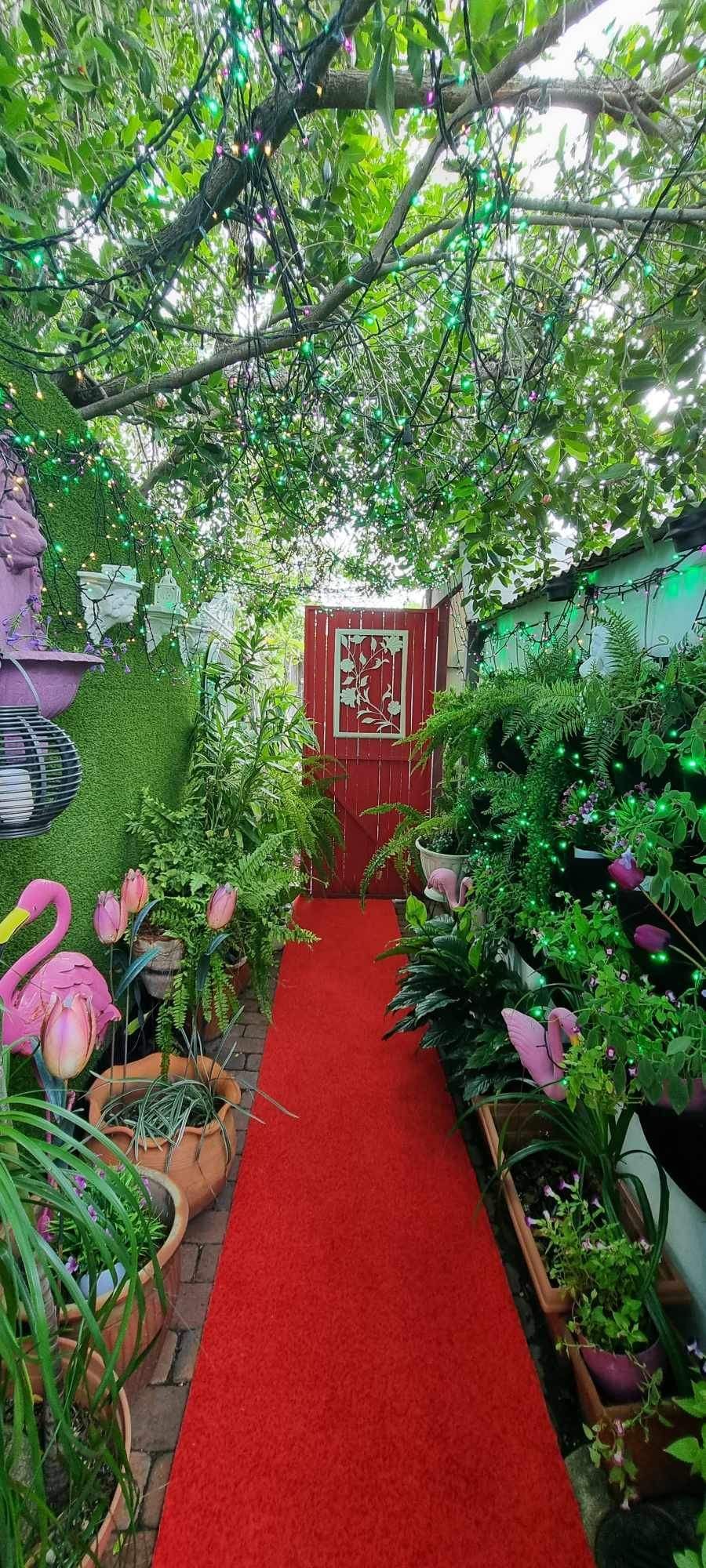 A Green Shelf With A Vase Of Flowers On It — Wayne & Adele's Garden of Eating BYO Restaurant In South Townsville, QLD