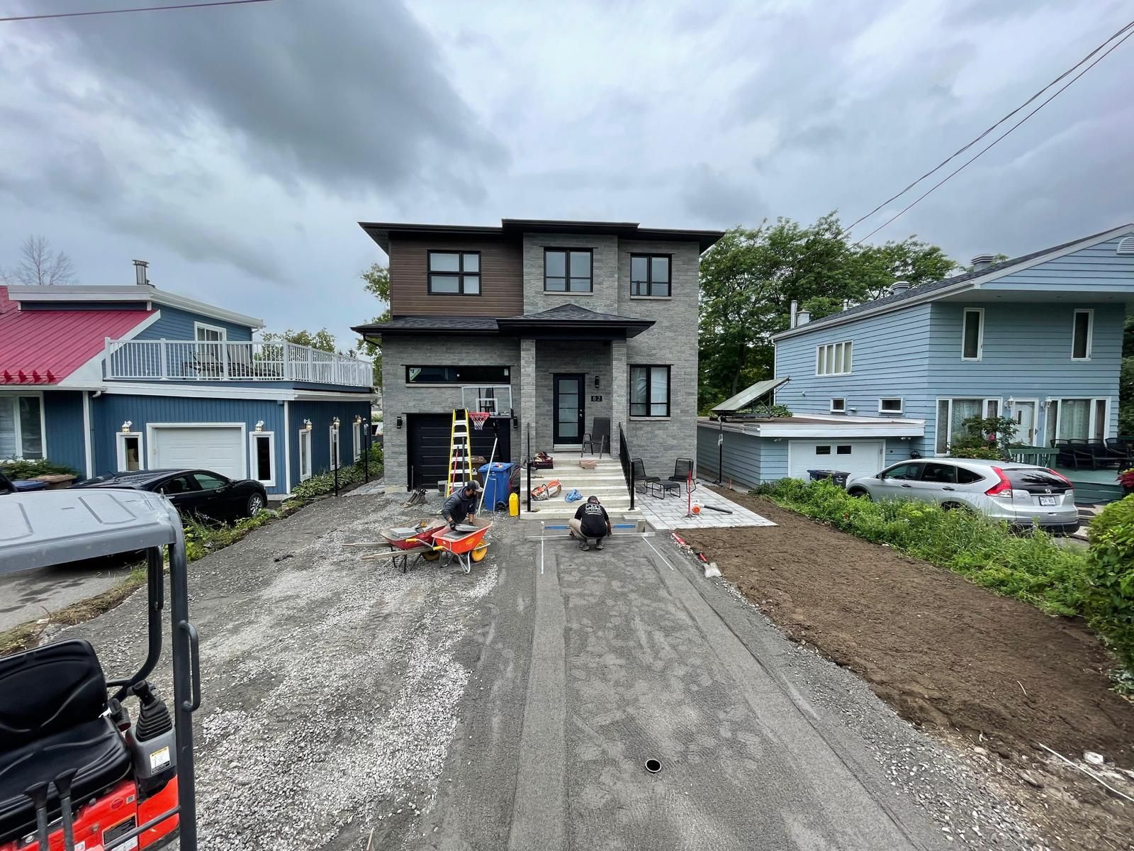 Une voiturette de golf est garée devant une maison en construction.