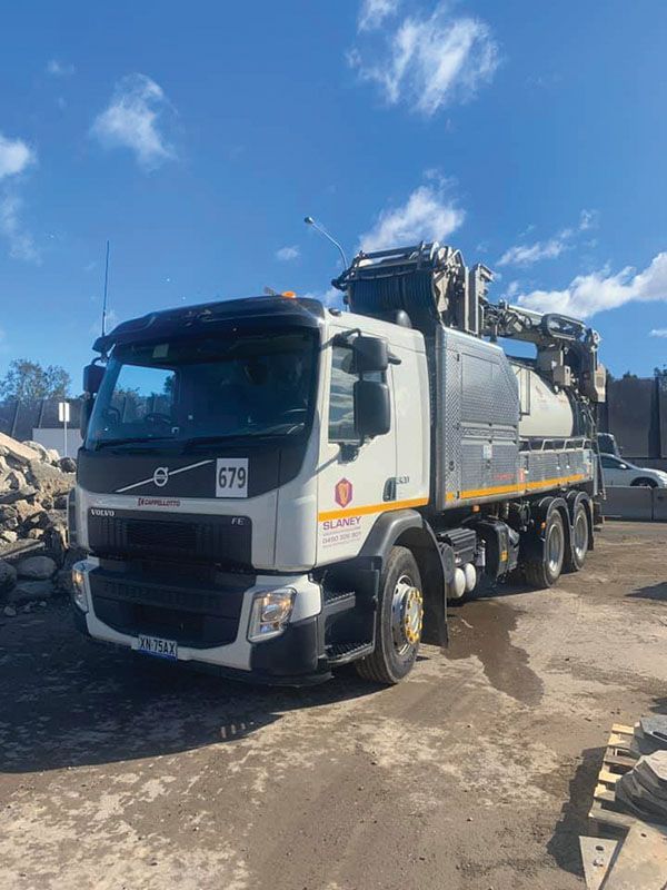 A large white truck is parked in a parking lot.