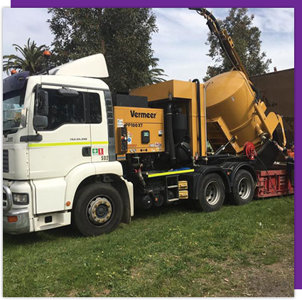 A yellow and white truck with the word vermeer on it