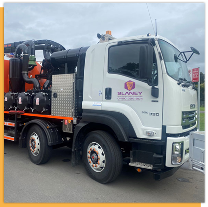 A white truck with the word slaney on the side