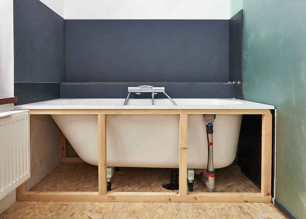 a bathtub is under construction in a bathroom