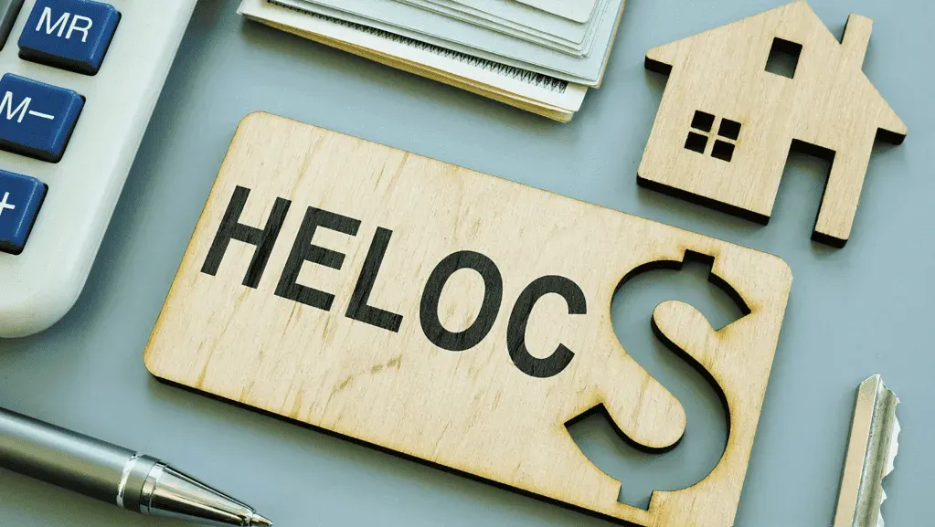 Notary notarizing HELOC documents as homeowner signs for a secure home loan.
