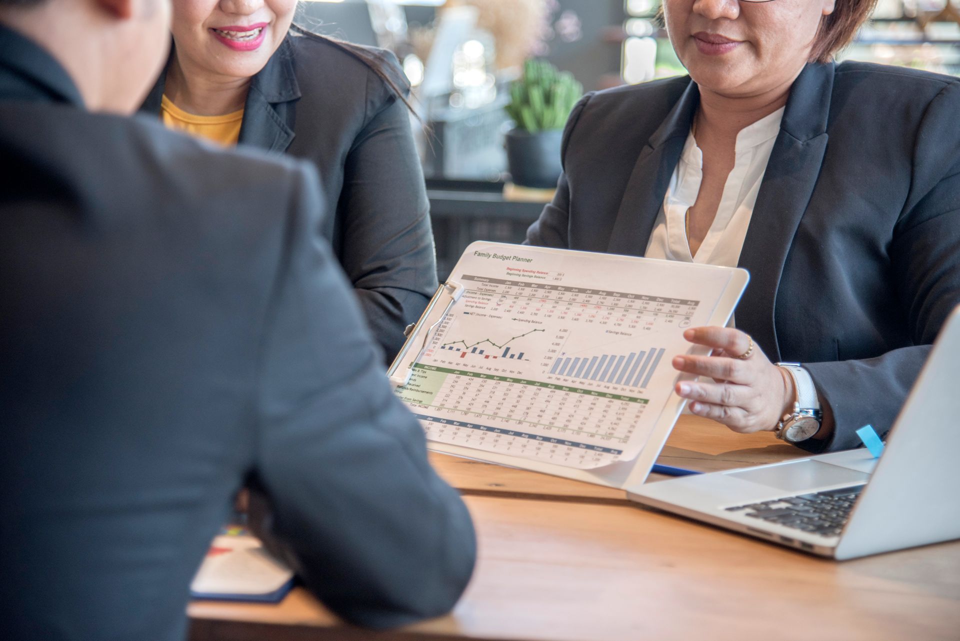 A young woman is talking to an older woman in a wheelchair.