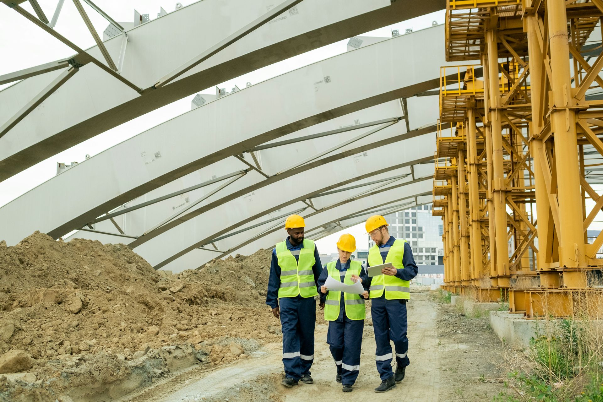 A young girl is sitting at a table with an older woman standing behind her.