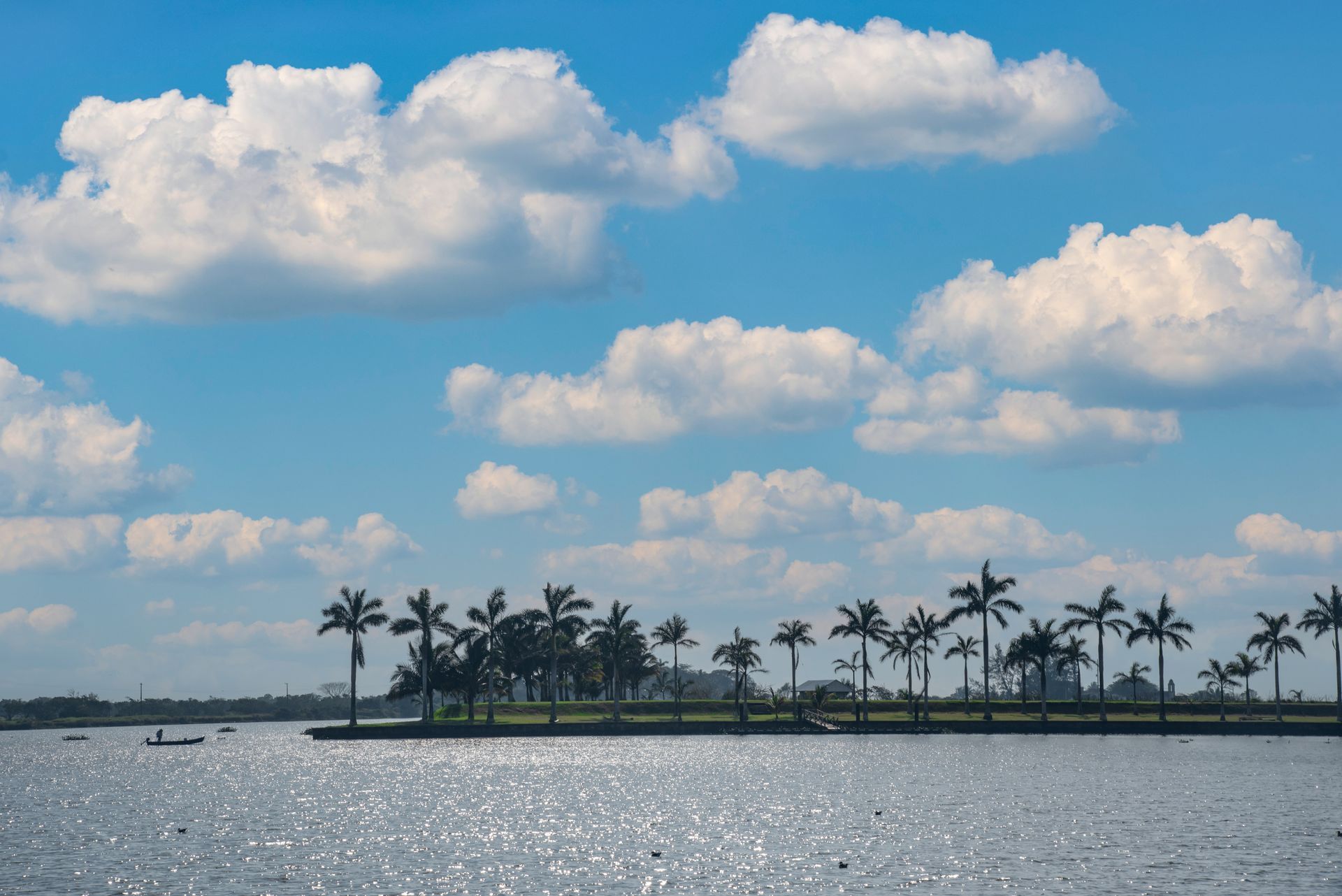 A young girl is sitting at a table with an older woman standing behind her.