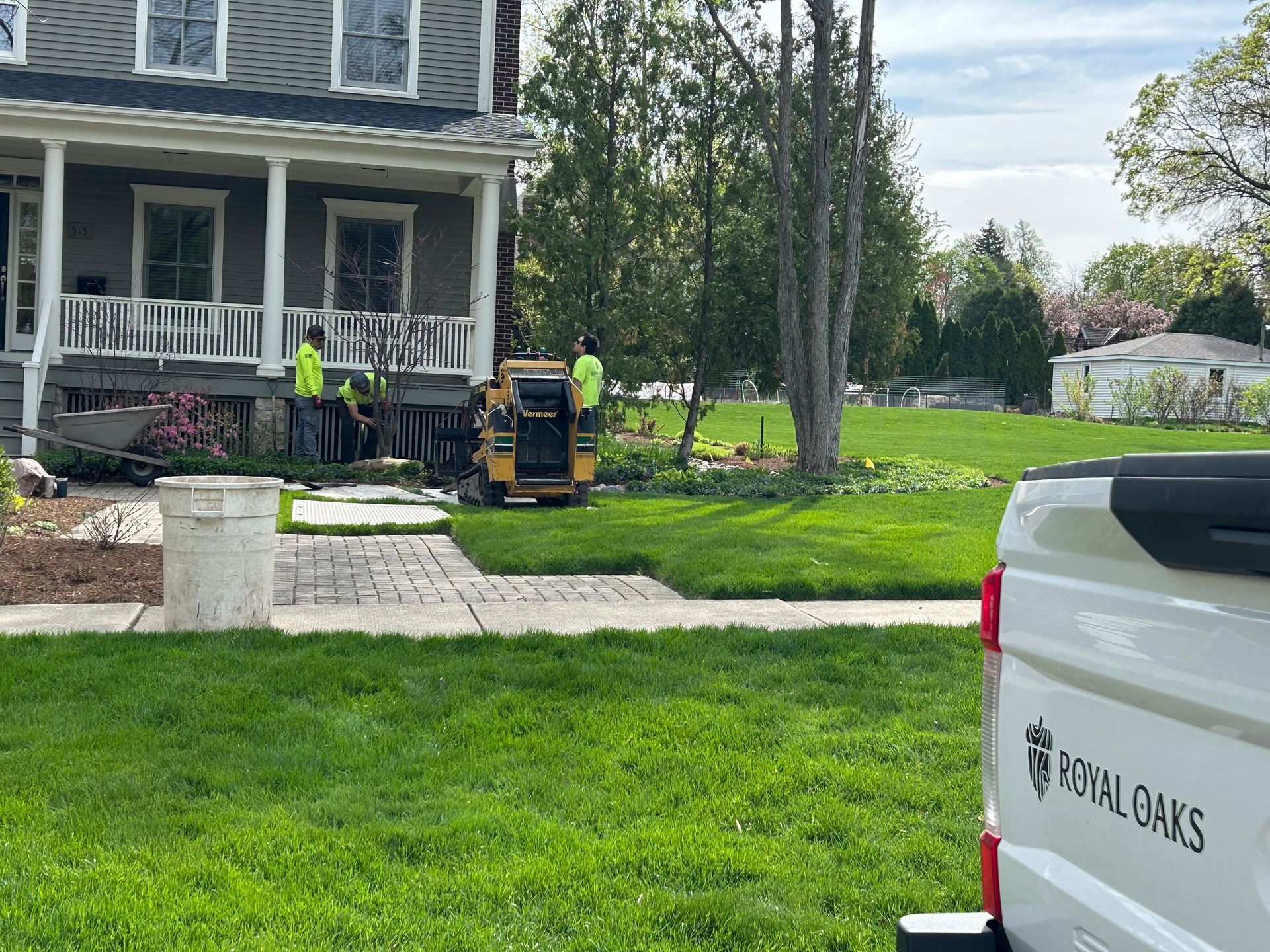 A white truck is parked in front of a house.