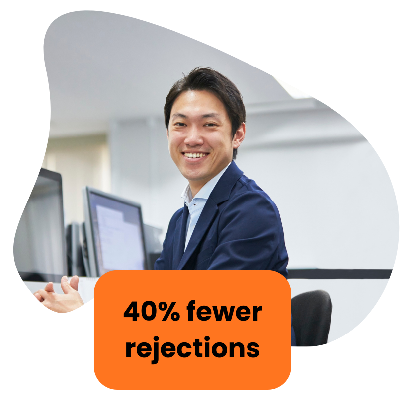 Smiling man at a computer, orange box reads 