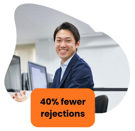 Smiling man at a computer, orange box reads 