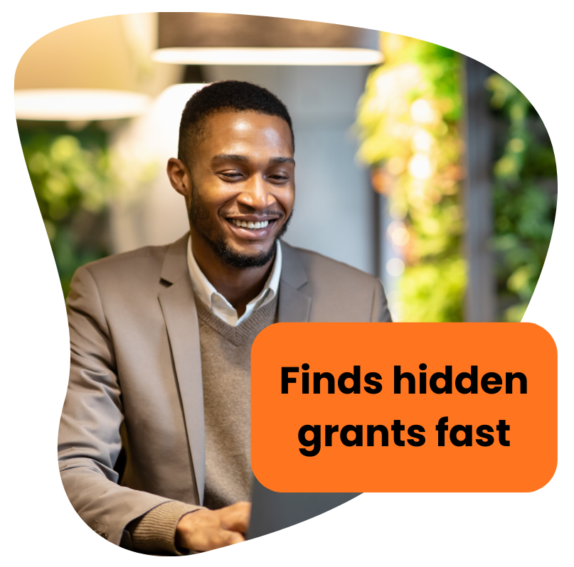 Smiling Black man looking at laptop; orange box says 