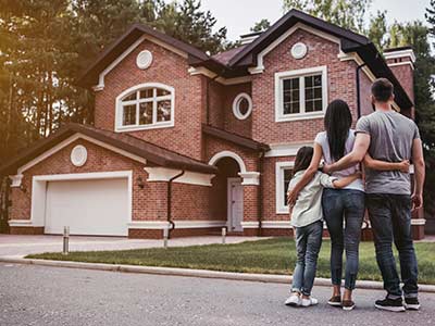 Home Insurance — Family Outside New House in Milwaukee, WI