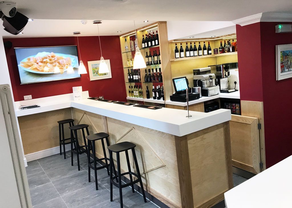 A restaurant with a long bar and stools