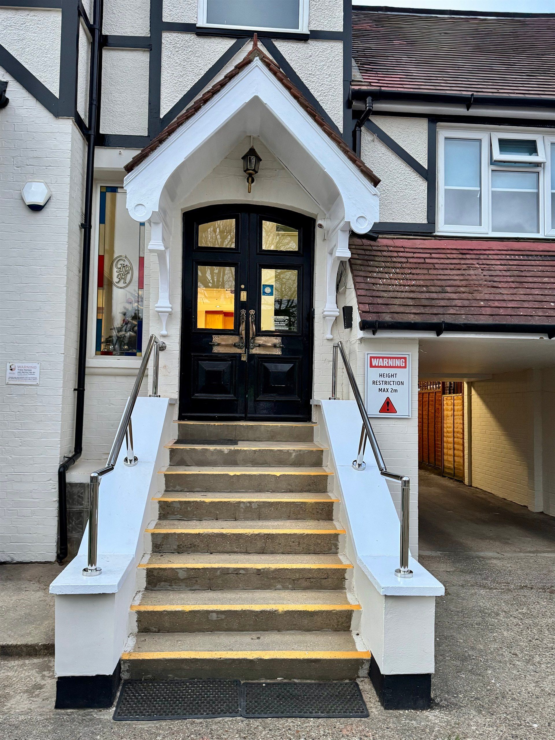 A house with stairs leading up to the front door