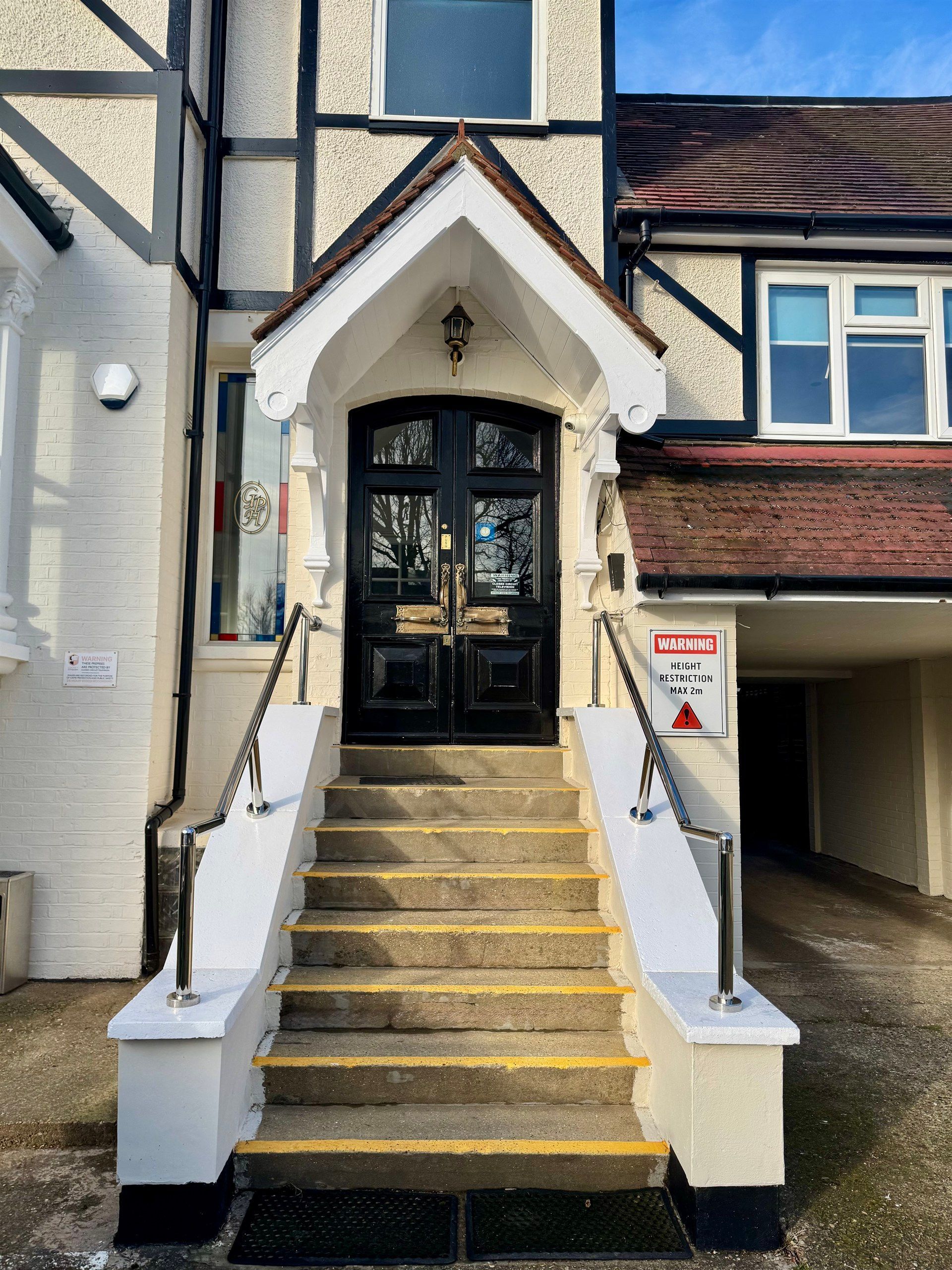 A house with stairs leading up to the front door
