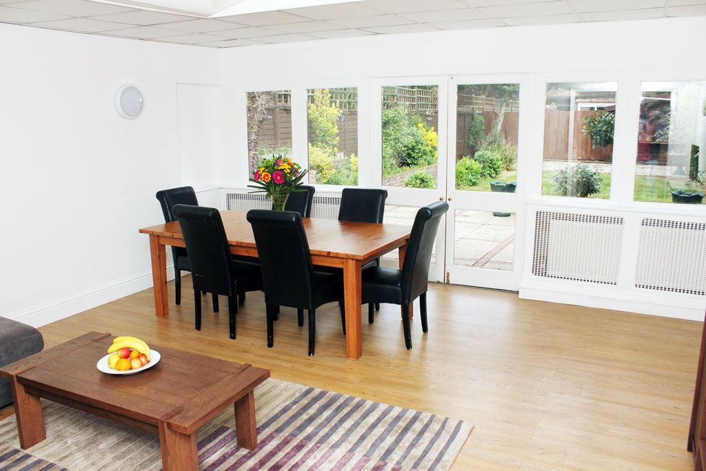 A living room with a dining table and chairs