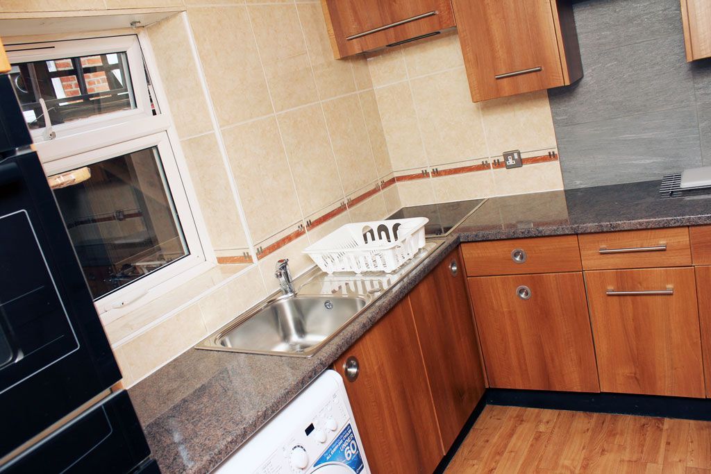 A kitchen with wooden cabinets and granite counter tops