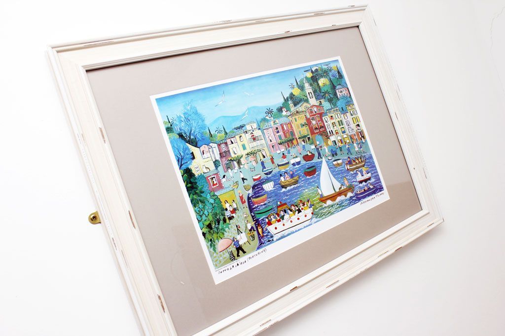 A framed painting is hanging on a white wall.