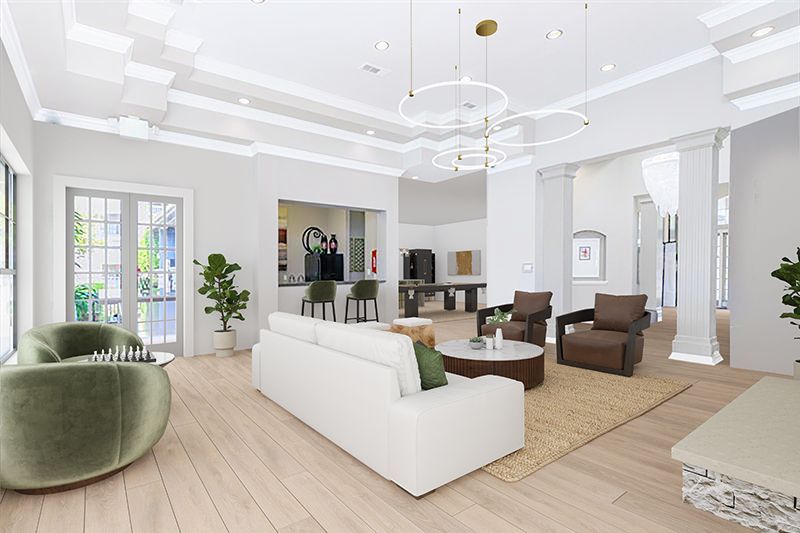 Bright, airy living room with white sofa, green chair, and neutral tones. Lounge area with a kitchen in the back.