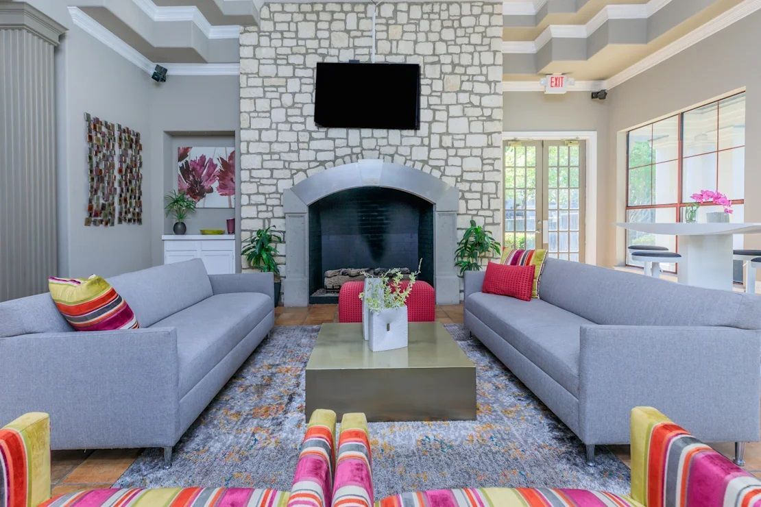 A clubhouse with two couches and a fireplace.