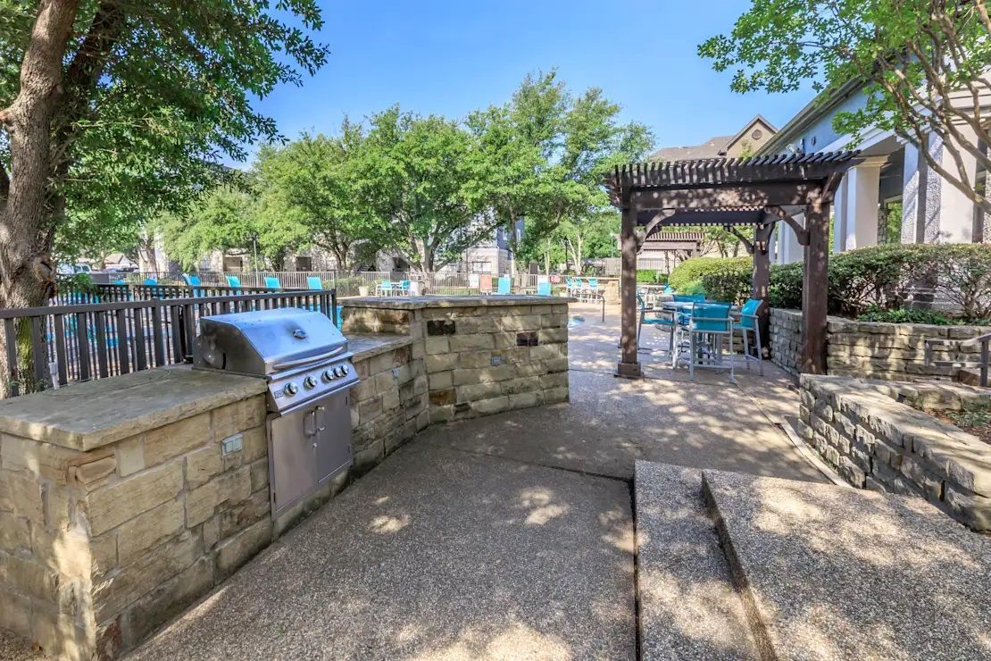 There is a grill in the middle of the patio area.