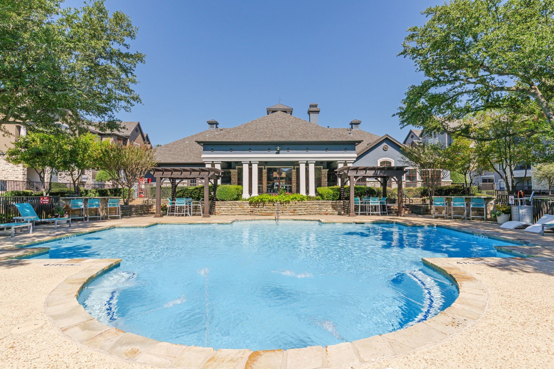 There is a large swimming pool in front of a building.