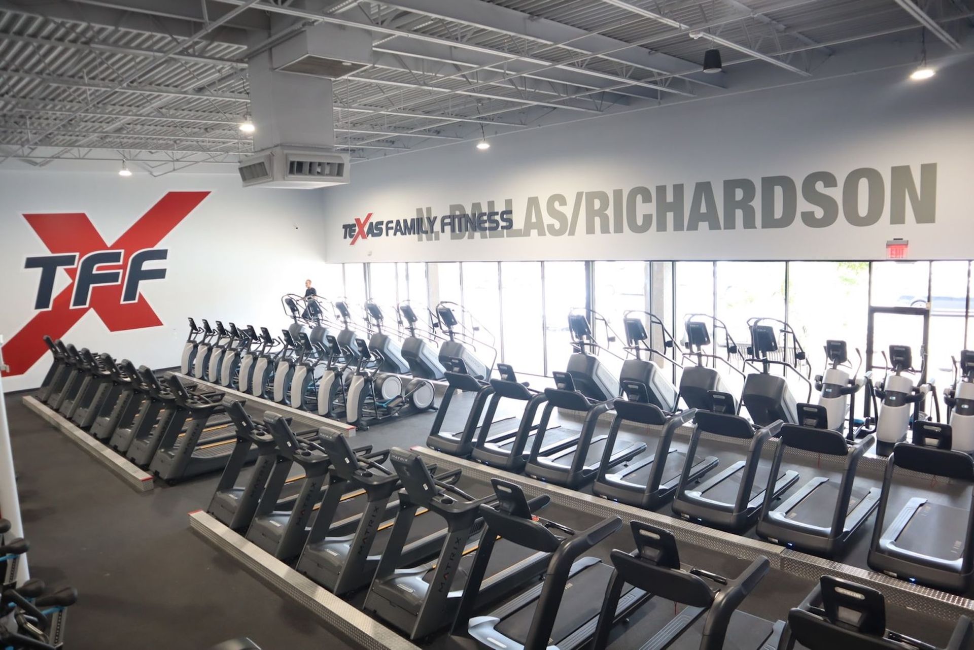 Interior of a gym with treadmills and exercise machines. 