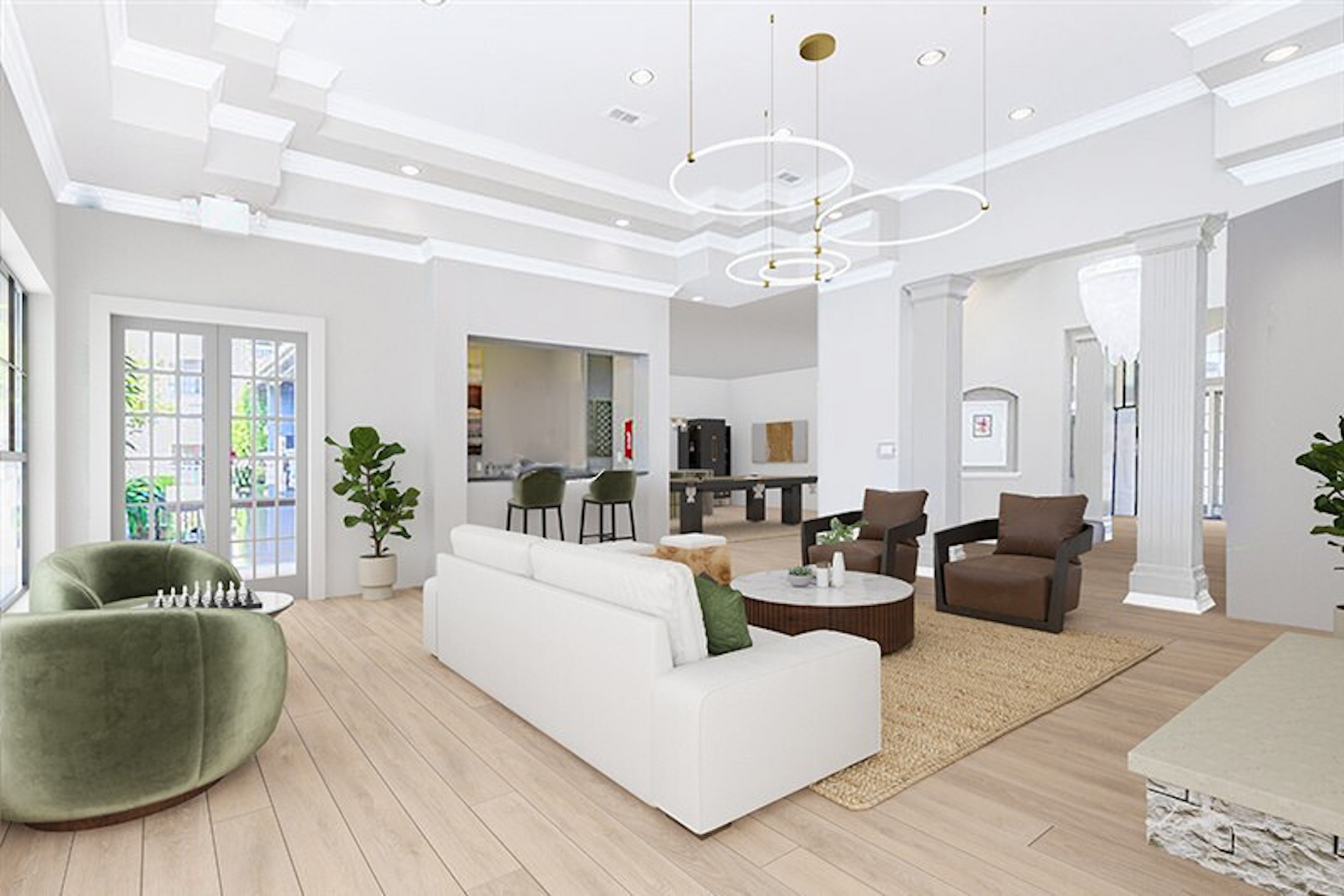 Bright, airy living space with white walls, olive green chair, and a white sofa. A kitchen counter is in the background.