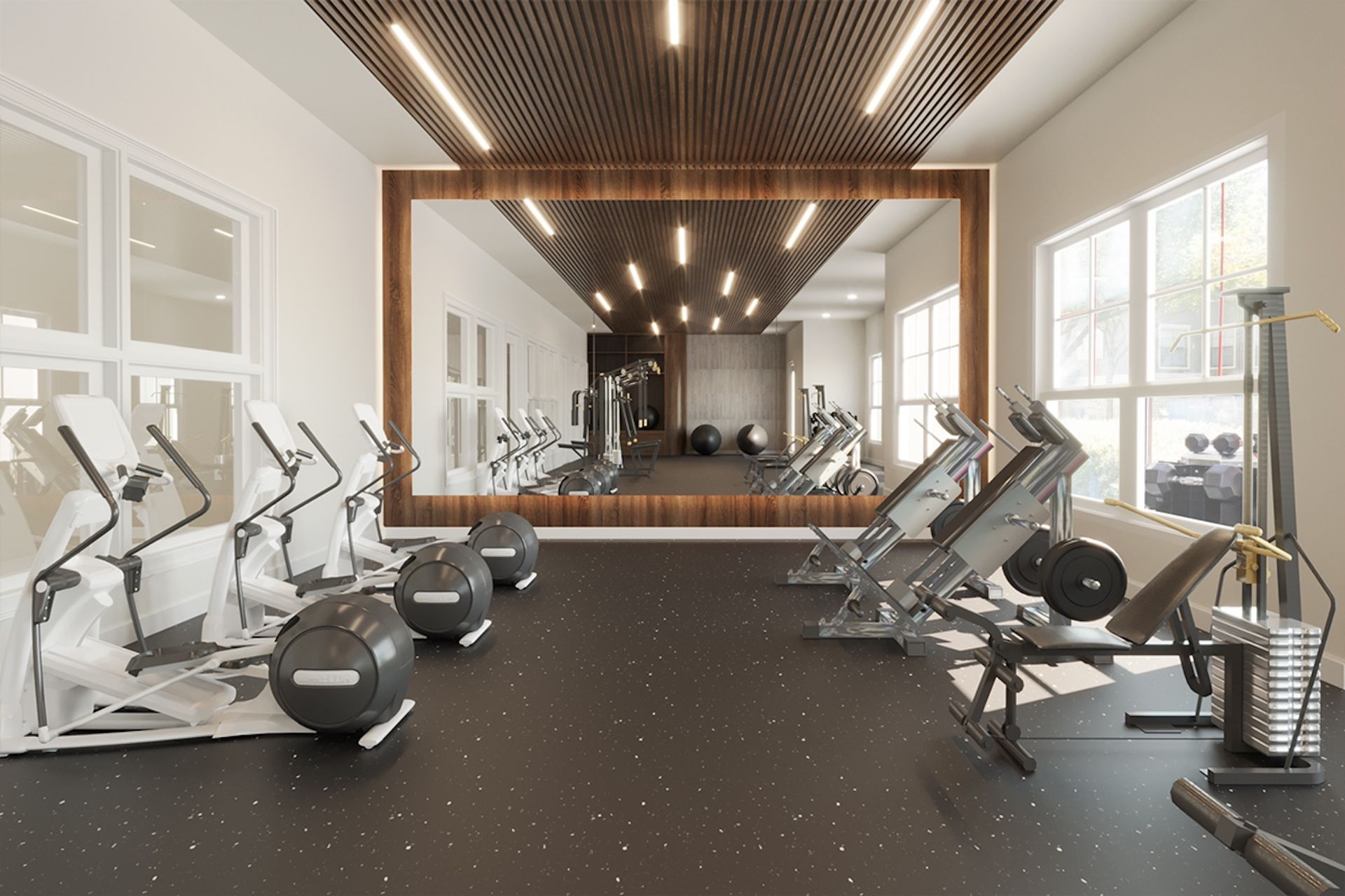 Gym interior with exercise machines, mirrors, and fitness balls; wood and light fixtures on the ceiling.
