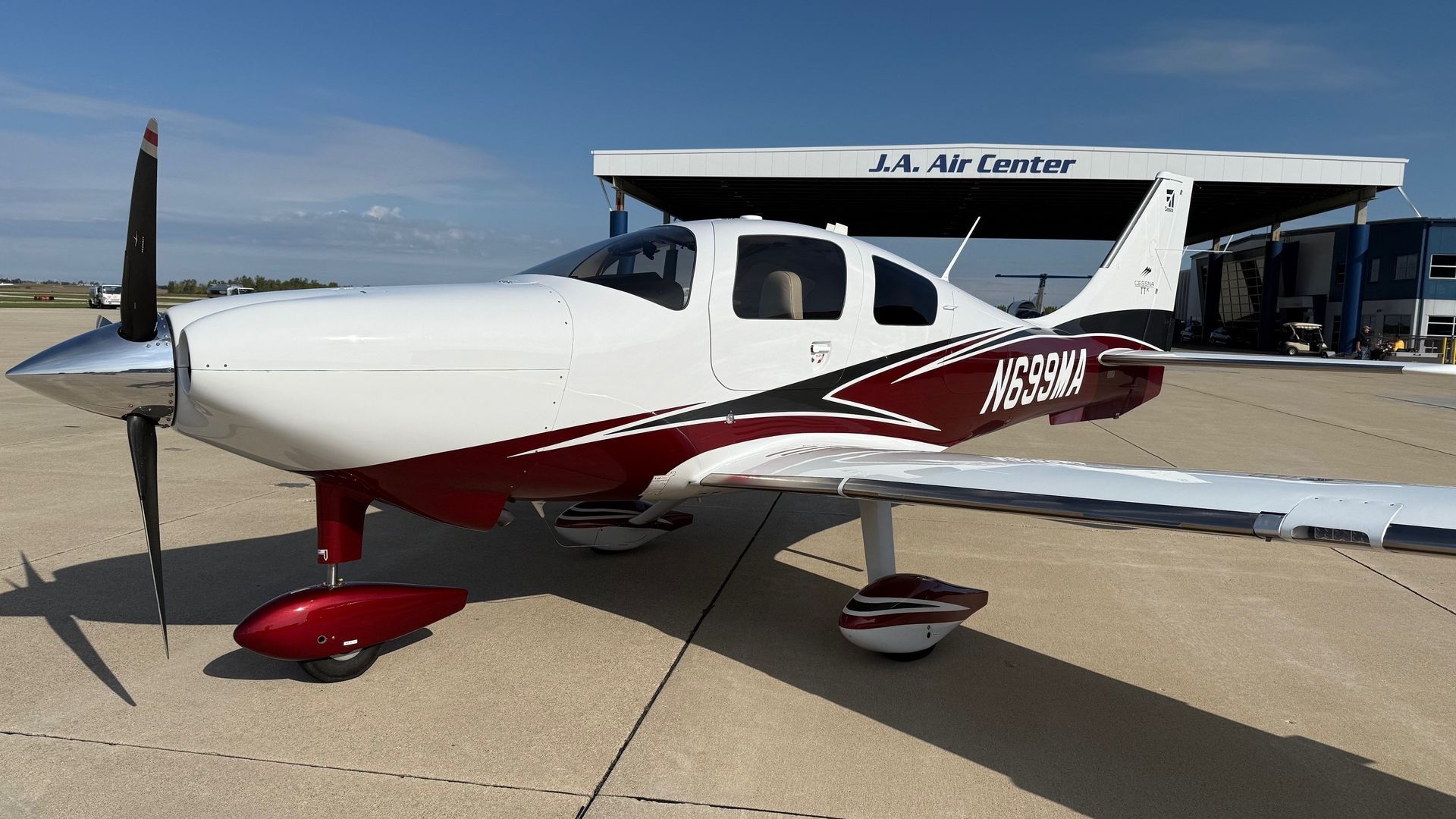 A small yellow and white plane with the numbers n355ac on the side