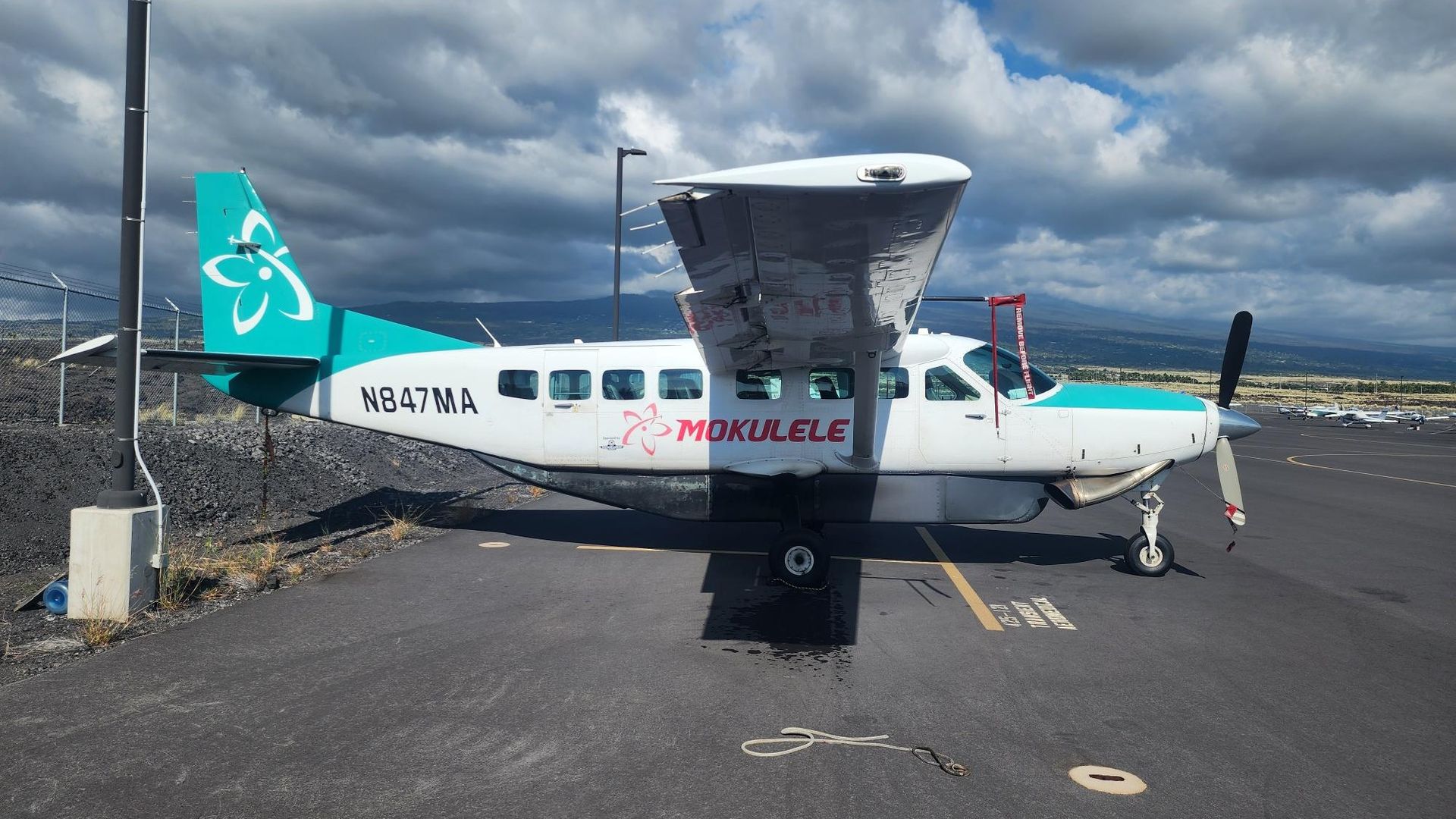 A small red and white plane with n224412 written on the side