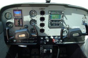 A cockpit of an airplane with a lot of instruments on it