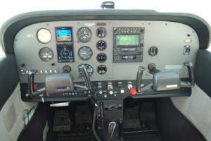 A cockpit of an airplane with a lot of controls