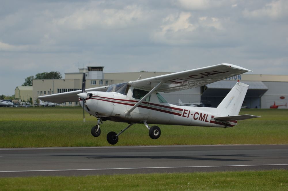 A small plane is taking off from an airport runway.