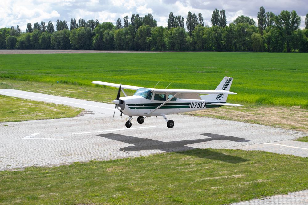 A small plane is taking off from an airport runway