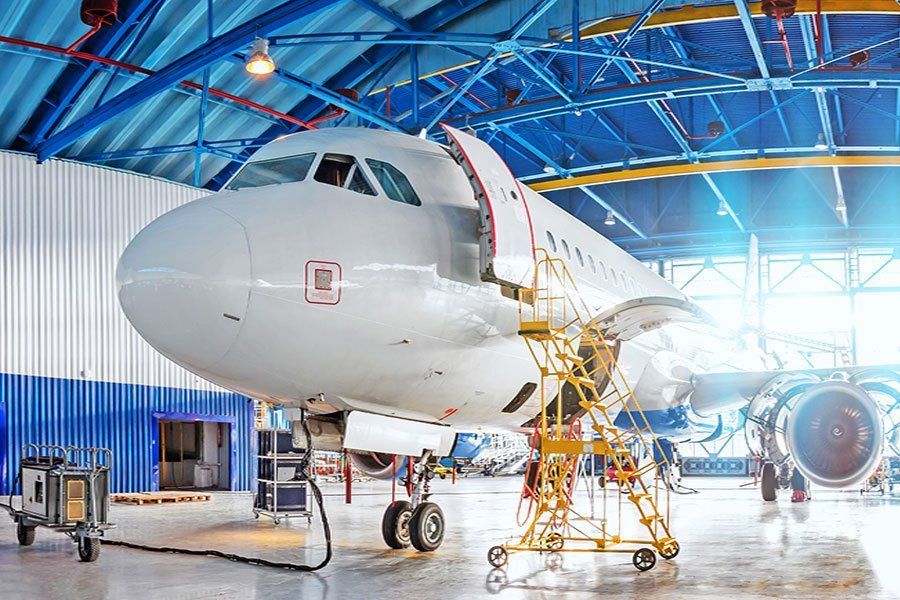 An airplane is being serviced in a hangar.