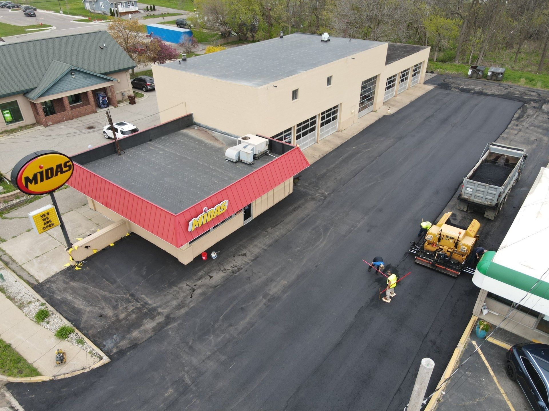 An aerial view of a building and a gas station.