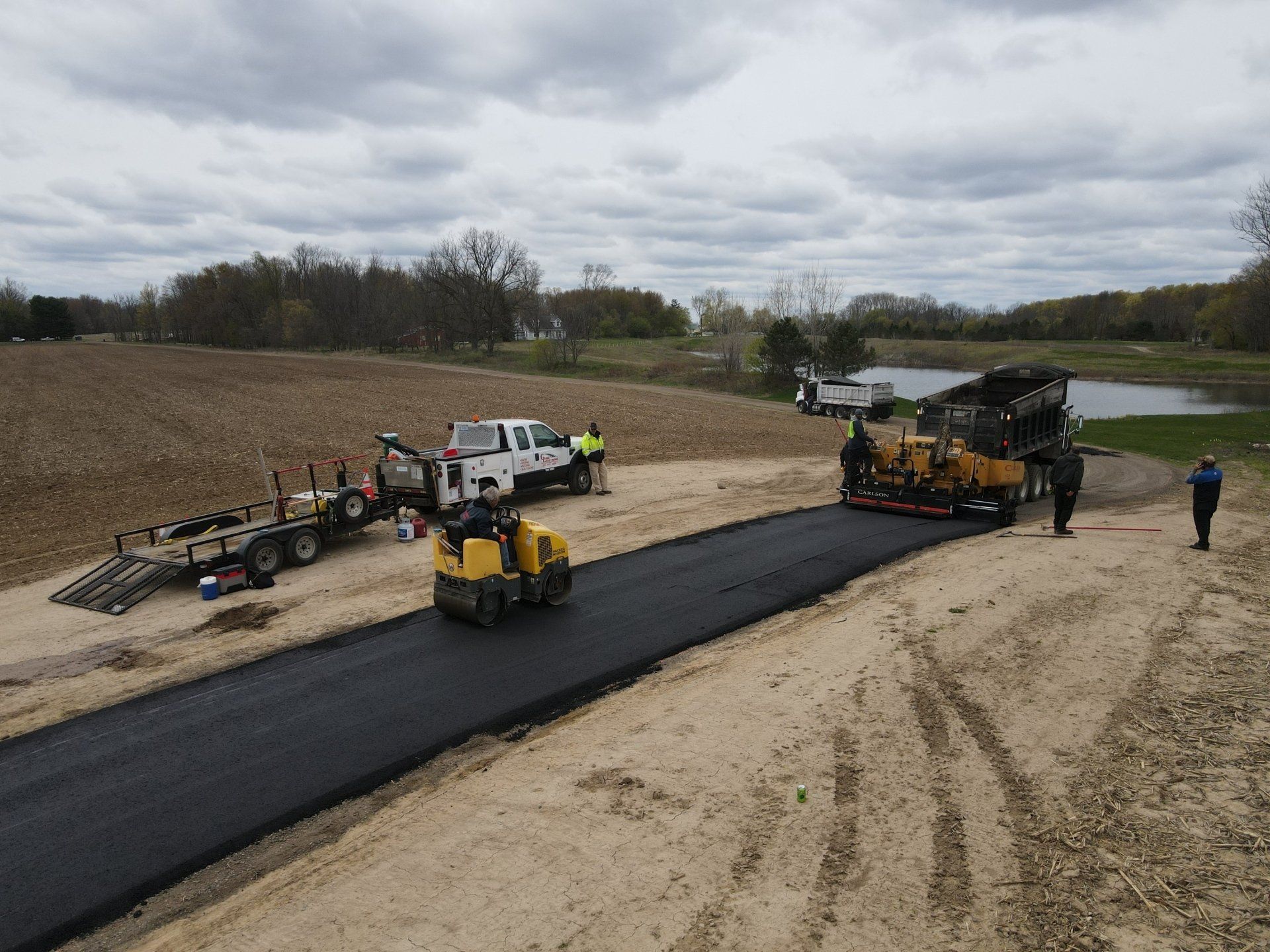 A group of construction workers are working on a road.