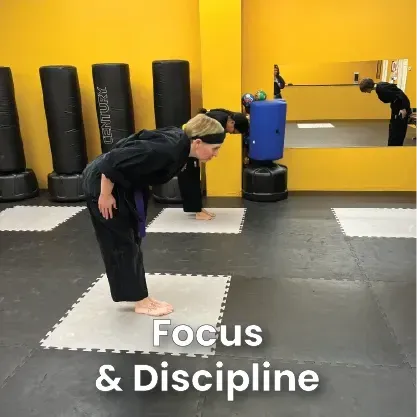 Martial arts students bowing in a dojo, emphasizing focus and discipline.