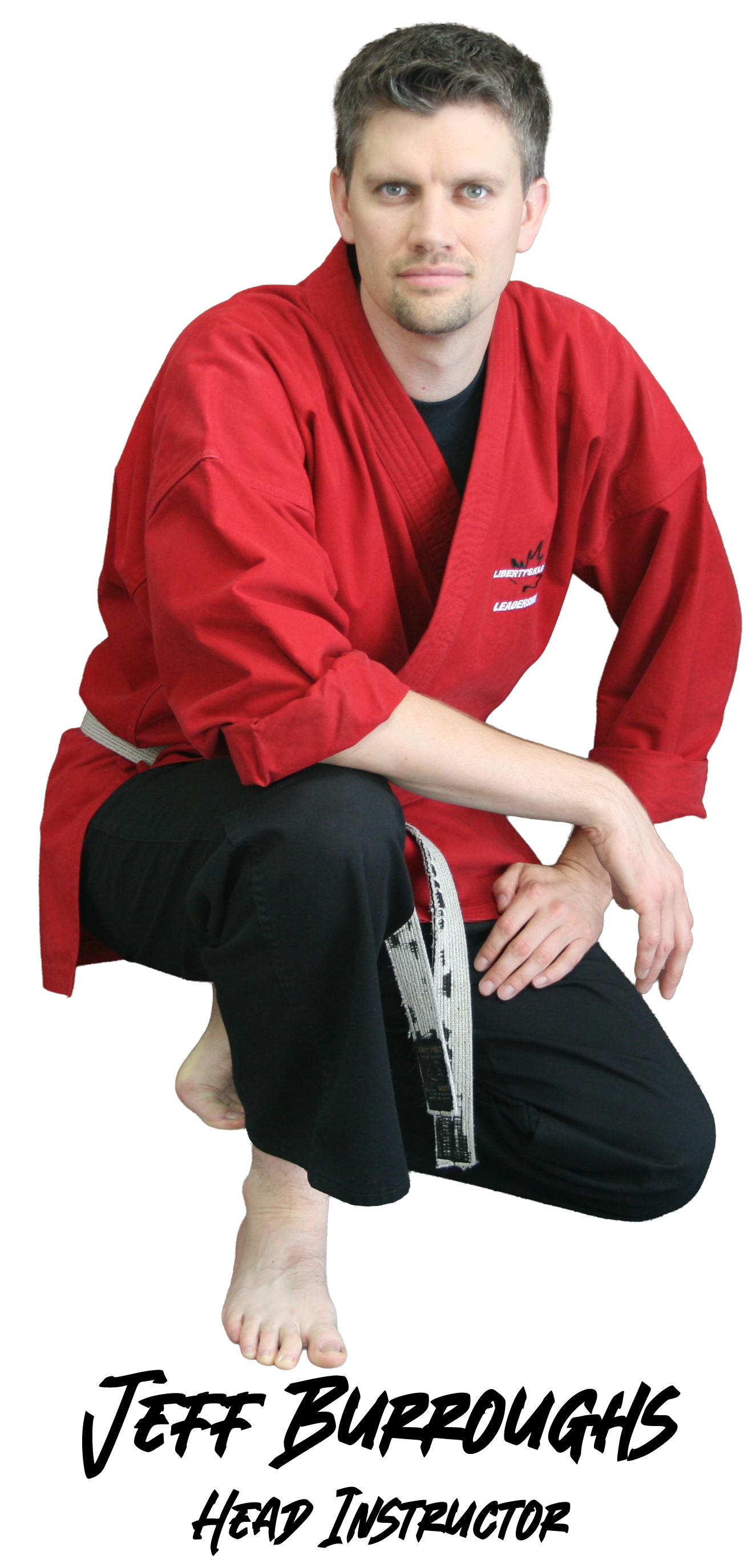 Man in red martial arts uniform, squatting. Black belt. 