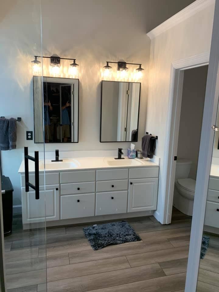 A bathroom with two mirrors and a sink.