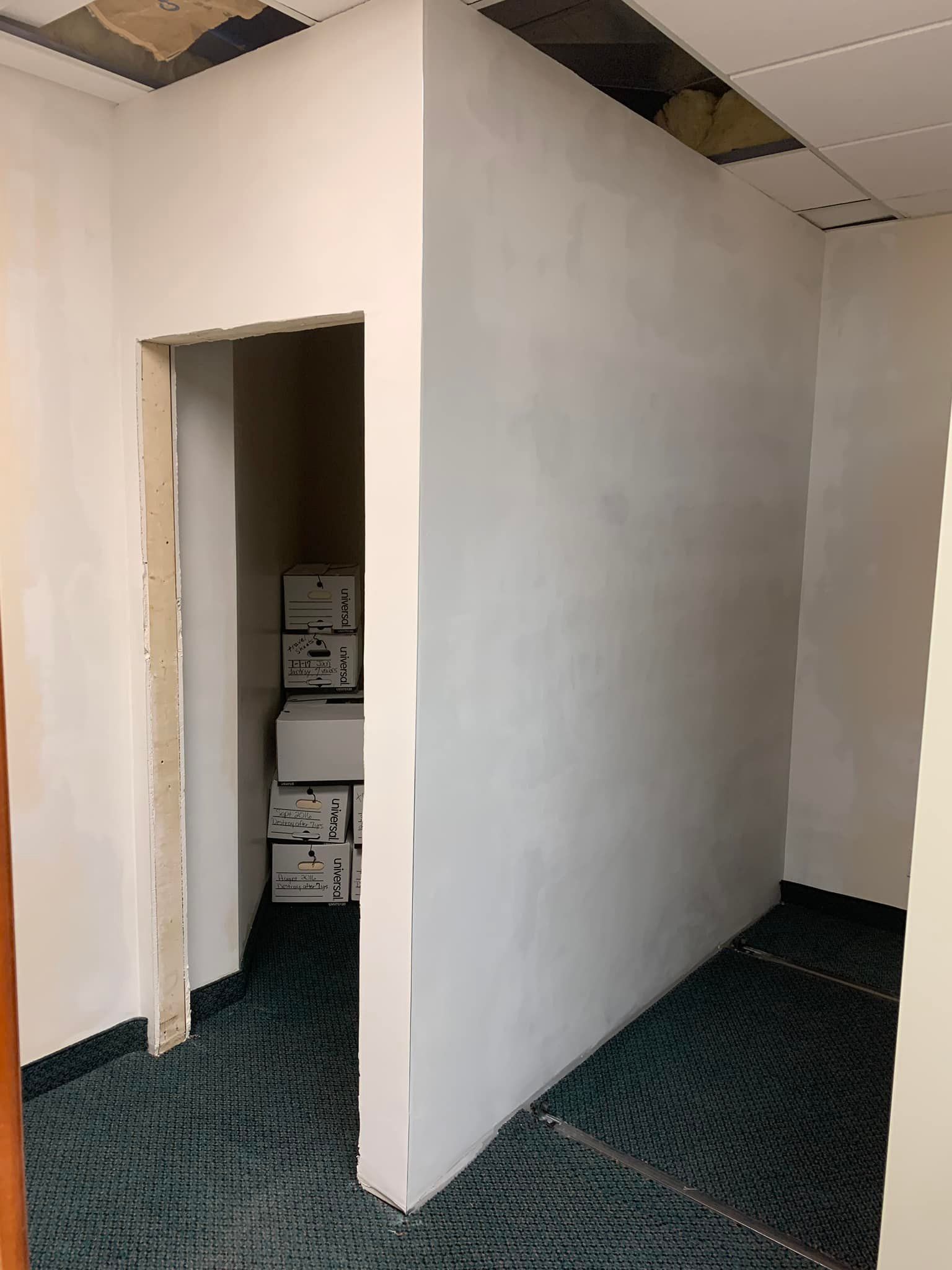 A walk in closet with lots of shelves and a wooden floor.
