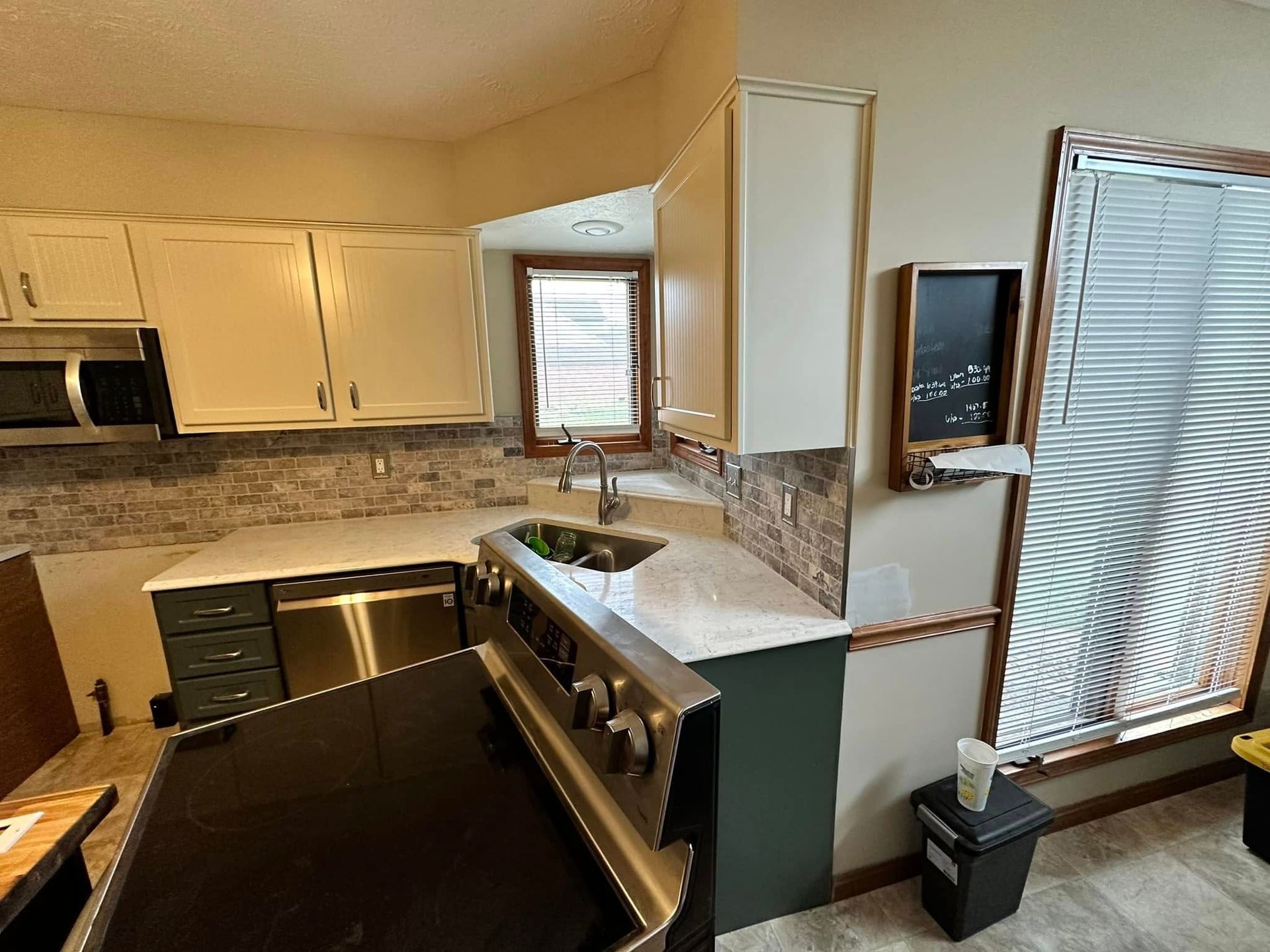 A kitchen with stainless steel appliances and white cabinets