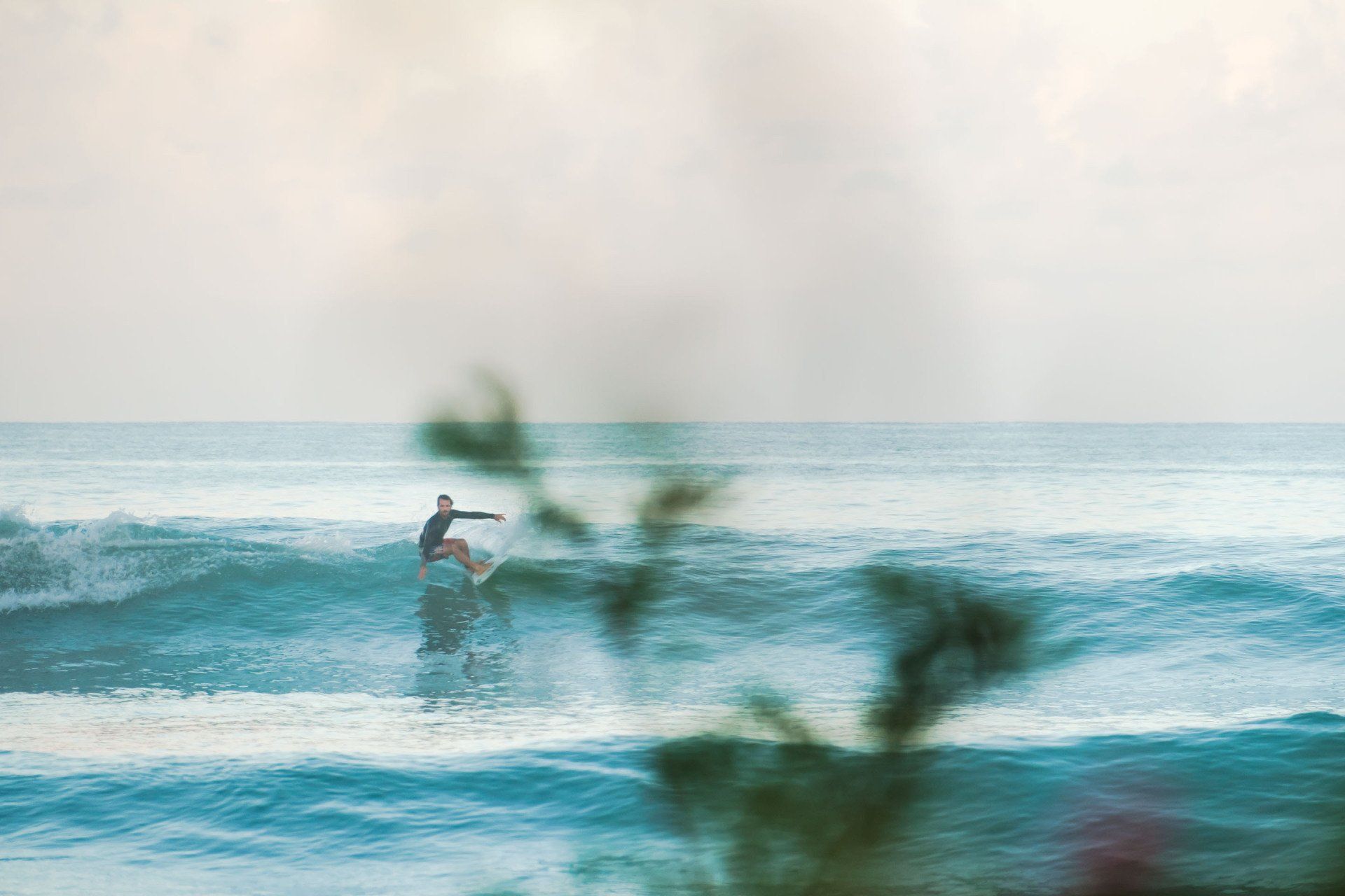 A surfer enjoy a wave in the morning at St. Martin