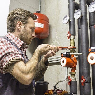 man fixing water pipe — Hipwell Plumbing in Tweed Heads, NSW