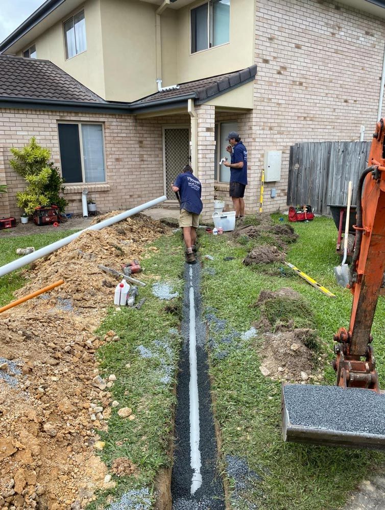 Plumber working on pipes
