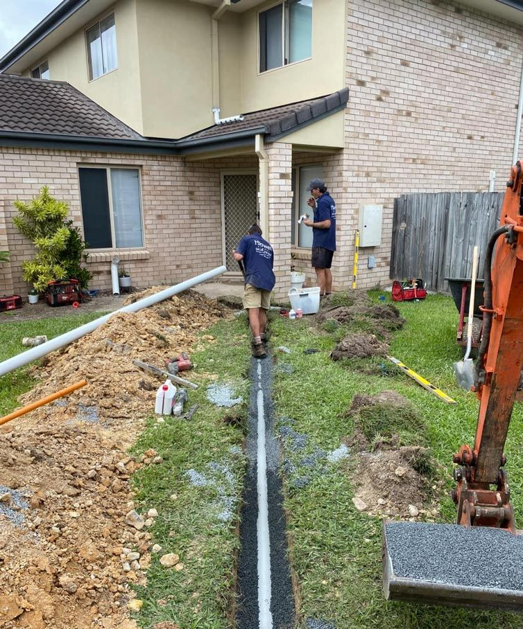 Plumber working on pipes