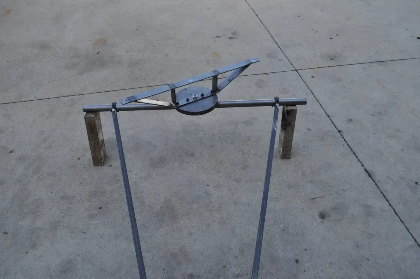 A metal object is sitting on a concrete surface