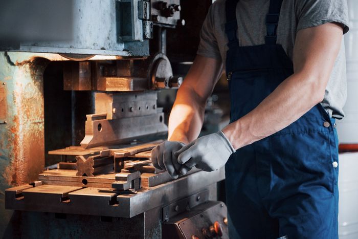 A man is working on a machine in a factory.